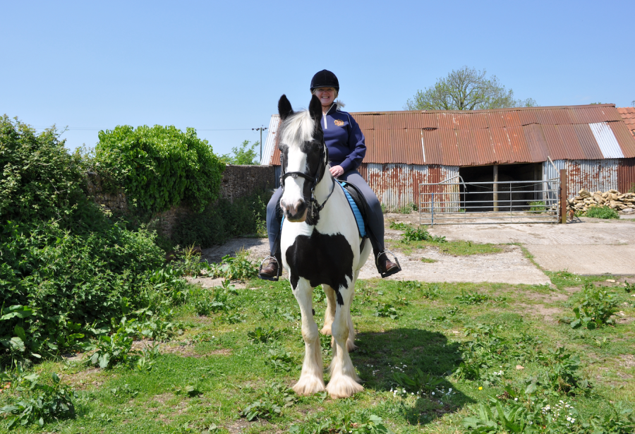 Julie is pictured on her cob Panda wearing the Lusso Signature Riding Leggings she tested for five months