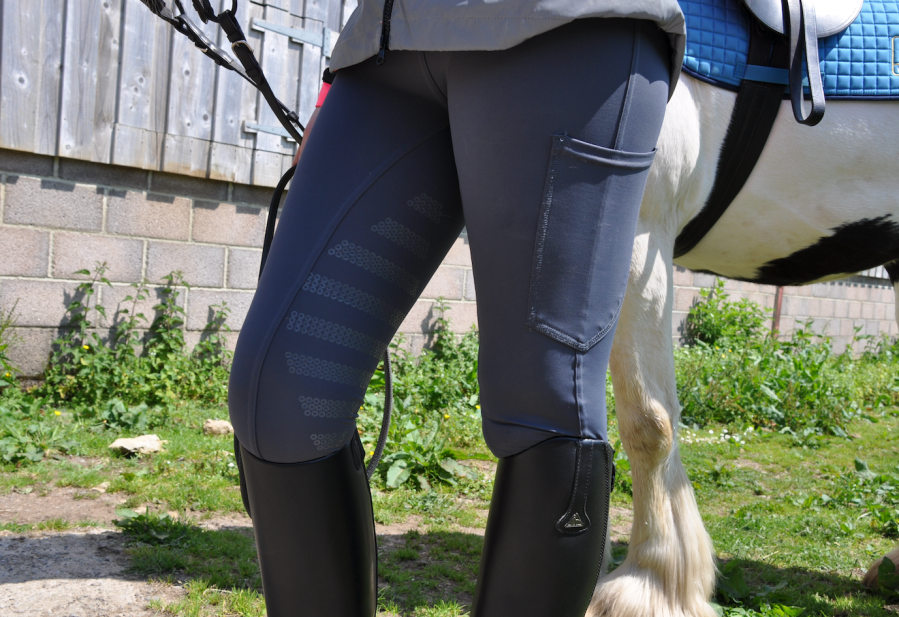 Pictured are the Lusso Signature Riding Leggings, showing silicone grip on the inner thigh and a large phone pocket on the outer thigh