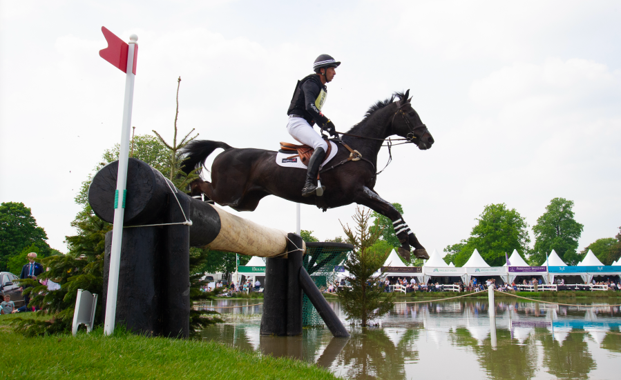 Tim Price is pictured jumping into the Badminton Lake on Vitali