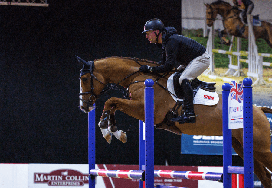 Oliver Townend is pictured showjumping a chestnut horse at Your Horse Live in 2023